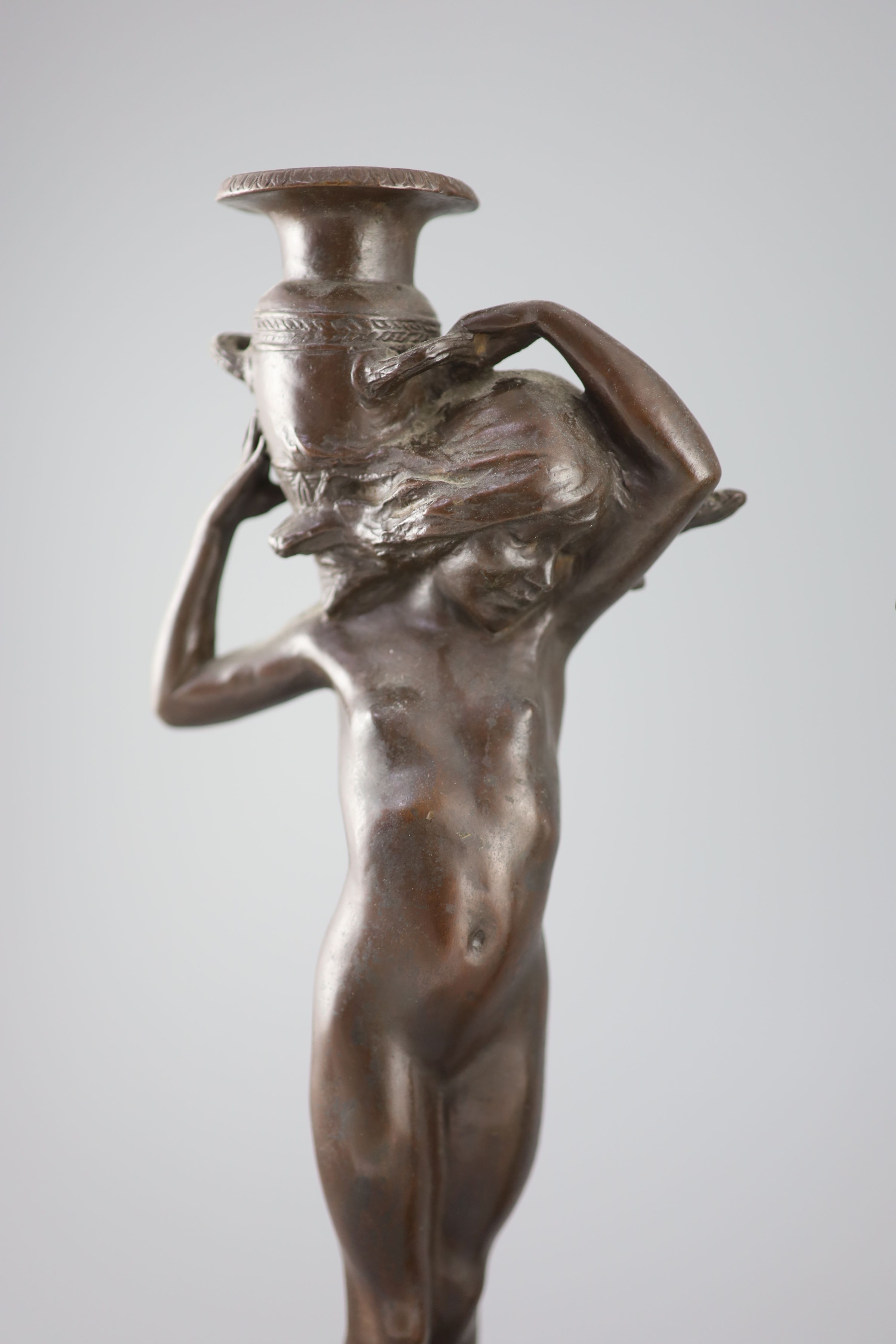 After Edward Francis McCartan (1879-1947). A pair of Art Nouveau bronze candlesticks, height 16.75in.